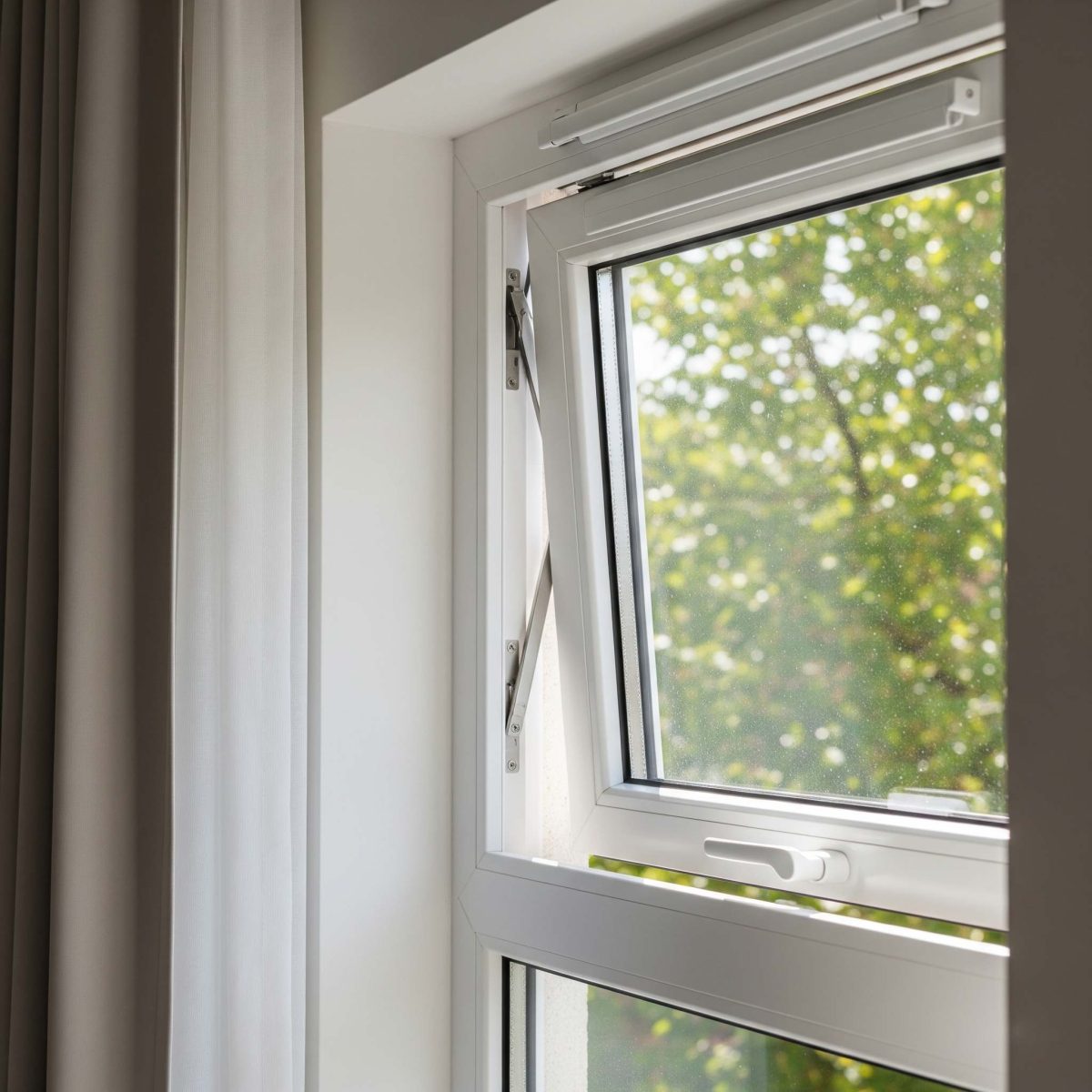 A uPVC tilt and turn window tilted inwards for ventilation.